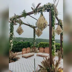 A mandap should feel sacred and breathtaking. I designed this modern rustic mandap with a wooden frame, delicate chandeliers, and wild pampas grass, set against a stunning natural backdrop for an open-air ceremony.