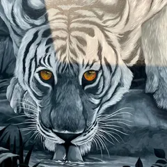 A close up of the tiger mural, focusing on its face as it laps water. This perspective highlights the realistic details in the water's reflection and the texture of the tiger's fur, achieved with careful brushwork.