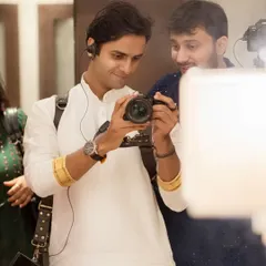 My team and I work closely on every shoot. Here, we are discussing the framing and lighting for the next shot. This teamwork is essential to ensuring a smooth, creative, and enjoyable pre-wedding photoshoot experience for you.