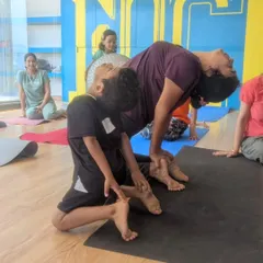 Here I am assisting a student with his camel pose to ensure he achieves a deep, safe stretch. Proper guidance is key to helping kids improve their flexibility without straining.