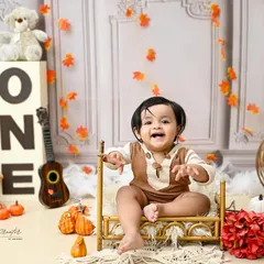 A huge, happy grin from this adorable sitter. At this age, babies are full of expression, and this teddy bear-themed shoot was the perfect way to capture his joyful personality.
