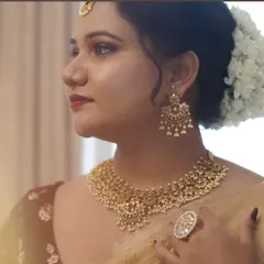 A detailed close-up of this classic bridal look. You can see the precision of the eyeliner, the soft contouring, and the beautiful antique gold jewelry that completes the style.