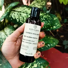 Our Down to Earth Revitalizing Hair Oil is a potent blend of more than 10 cold-pressed oils, including moringa, black cumin, and brahmi. It helps reduce hair fall, tackles scalp issues, and promotes growth.