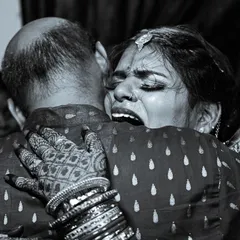 The vidaai is one of the most emotional moments in an Indian wedding. I focus on capturing the real, unfiltered feelings, like this powerful embrace between a bride and her father. This black and white photo highlights the intensity of the moment, creating a memory that will last forever.