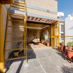 The family space at Audumbara seamlessly transitions to a verdant terrace, with the swing acting as the centerpiece of this indoor-outdoor sanctuary.