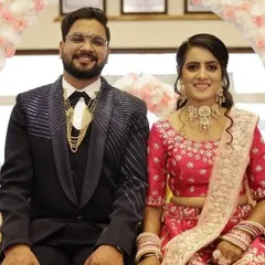 A beautiful couple at their reception. The bride is wearing a custom pastel pink choker set that I designed to match her stunning pink lehenga.