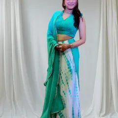 For a Sangeet performance, the outfit must be as vibrant as the celebration. I designed this custom tie-dye lehenga with a sparkling mirror-work halter blouse to reflect the client's personality and ensure she shines during her special dance.