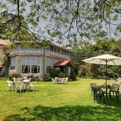 The expansive lawn and outdoor seating area at the hotel, perfect for events or for guests to relax and enjoy the natural surroundings.