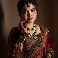 Lavanya looking serene and beautiful. The soft lighting highlights the intricate details of her jewelry and the flawless finish of her makeup.