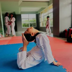 This student holds a deep backbend, a testament to the incredible flexibility developed through our rigorous stretching routines.