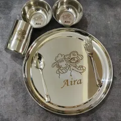 A complete stainless steel dinner set for kids, engraved with their name and a fun cartoon character like Shaun the Sheep.