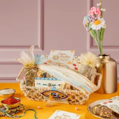 The Banter Rakhi Hamper is packed with goodies to ward off negativity. It includes an Evil Eye rakhi, granola, assorted brownies, nut bars, and sugar-free mithai, all wrapped in a charming basket.