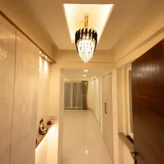 The elegant hallway in Bhavinee's home, featuring a stunning crystal chandelier that adds a touch of glamour and sophistication to the entryway.