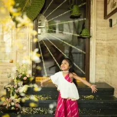 A moment of pure joy. This little client looks radiant in our classic White and Rani Pink Jumpsuit, a perfect outfit for a festive family gathering.