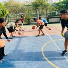 Fundamentals are everything. Here, our players are locked in on a ball-handling drill, improving their control and coordination. Mastering these basics is key to becoming a versatile player.