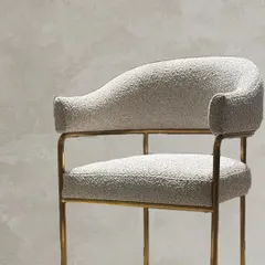 Commissioned for a client, this chair with a matching footrest is a study in understated luxury. Upholstered in soft bouclé, it offers both texture and comfort with a minimal silhouette.