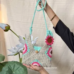 Our pastel sling bag held up to show its full design. The combination of beige, mint, and pink is soft and lovely.