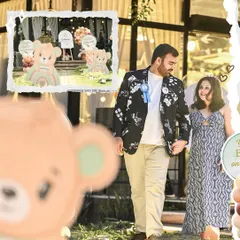 Capturing the happy parents-to-be at their boho-themed teddy bear baby shower. The outdoor setting is decorated with custom bear cutouts and neutral-toned balloons for a relaxed and stylish event.