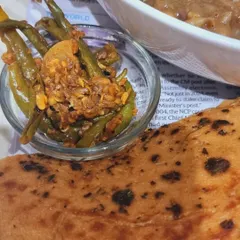 A close-up of my zero-oil Matra Kulcha, served with a side of spicy green chilli pickle. This is a classic street food dish from Delhi, made healthy without compromising on the authentic taste.