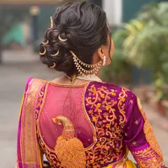 For my Maharashtrian brides, I create authentic and regal looks like this intricate bridal bun. The highlight is the traditional chandrakor accessory, which I place carefully to complement the textured updo and the stunning details of the Paithani saree. This style is all about honoring tradition with grace.