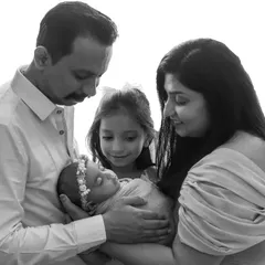 A beautiful family moment with an older sibling, made even more touching in classic black and white.