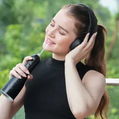The model enjoys the music while using the product, creating a sensory experience that enhances the product's appeal.