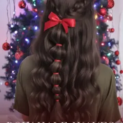 This bow half waves style combines the best of both worlds. A portion of the hair is pulled back into a bubble braid adorned with a bow, while the rest flows in soft waves, creating a romantic holiday look.