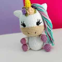 Another angle of the handmade unicorn amigurumi. She is small enough to sit in the palm of your hand and makes a very magical gift.