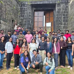 A large group of travelers in front of a historic fort. We love exploring the hidden gems and historical sites that we encounter on our journeys.