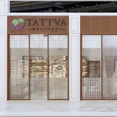 The storefront design for Tattva Wellness, a spa where serenity begins at the entrance. We used wood and intricate jali patterns on the glass to create a sense of calm and privacy.