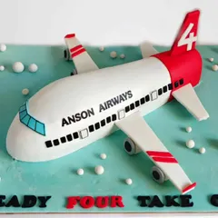 Ready for takeoff. This 3D aeroplane cake was sculpted entirely from whipped cream for a child's fourth birthday. It shows that even complex shapes can be achieved with a light, delicious finish.