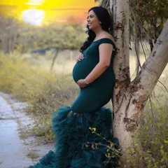 Basking in the golden glow of motherhood. This outdoor portrait captures the mom-to-be leaning against a tree, watching the sunset and dreaming of new beginnings.