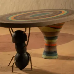 Inspired by nature's tiniest architects, the Weavers' Ant console is a celebration of strength and artistry. The tabletop features hand-poured pigments that mimic the colorful mountains of Argentina, held up by a sculptural ant cast in concrete and brass. It’s a playful, one-of-a-kind piece that tells a story.