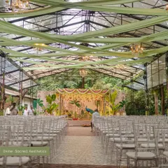 We designed this stunning South Indian wedding mandap in a glasshouse, blending the lush green outdoors with traditional decor. The custom-painted backdrop featuring a majestic peacock and tropical foliage created a vibrant yet sacred atmosphere for the ceremony.