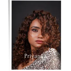 A stunning shot from the portfolio of hair student Priyanka. Her model's curly hair is expertly cut and styled, complemented by creative leopard-spot makeup for a truly unique and wild look.