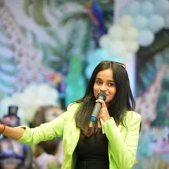 In my element with a mic in hand at a jungle-themed birthday party. I love tailoring the event to the theme and making sure the kids and adults are all entertained.