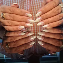 A beautiful set of pearly, off-white stiletto nails that look both elegant and trendy.