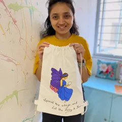 A participant shows off the fairy-themed backpack she painted. This workshop is perfect for unleashing your creativity on a functional item.