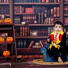 Ready to cast a spell. This portrait from a Harry Potter themed shoot shows the full setup, including the library backdrop and Halloween-inspired pumpkin props.