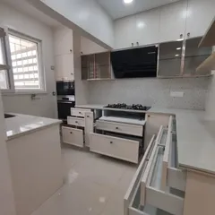 A real-life look at a completed PU finish kitchen, showcasing the various drawers and cabinets. I design for maximum utility, ensuring every inch of space is used effectively.