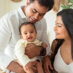 A perfect family moment, filled with smiles and warmth. This 6-month milestone session shows how I incorporate parents to create natural, loving portraits of the whole family together.