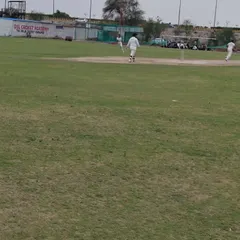 A glimpse of a match in progress at our ground. You can see our players in their whites, fully engaged in a competitive game, which is a regular feature of our training program.