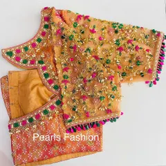 I work with delicate fabrics like net to create detailed designs. This blouse features multi-color threadwork, Zari, and bead embroidery on the net sleeves, with a matching heavy border on the neckline.