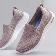 A pair of women's Skechers Go Walk shoes appearing to float in front of a mirror. This technique adds a sense of lightness and sophistication to the product, perfect for marketing comfortable footwear.