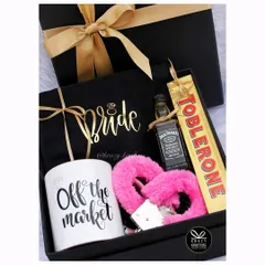 A naughty and nice hamper for the bride who is 'Off the Market'. This fun box includes a custom mug, a mini bottle of Jack Daniel's, and some playful accessories like pink fuzzy handcuffs.