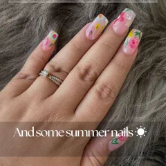 A close-up of these hand-painted summer floral nails. Each flower is detailed with care to create a beautiful, wearable garden on your fingertips.