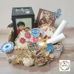 A still photo of the New Year hamper, showing the Urli candles, wooden portrait, and rotating lamp nestled in a decorative basket.