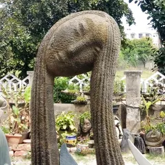 A bold sculpture can serve as the centerpiece of your garden. This large, abstract fiber-resin statue is lightweight, weatherproof, and adds a unique artistic touch to the outdoor landscape.