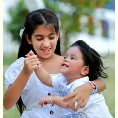 The pure joy of sibling love captured in an outdoor setting. We encourage playful interactions to get the most natural and heartwarming shots.