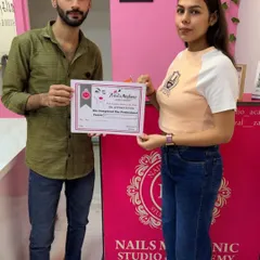 This student is officially a certified nail professional. It's always rewarding to hand over the certificate they've worked so hard for.